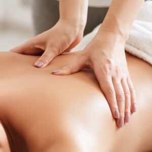 Body care. Young girl having massage, relaxing in spa salon